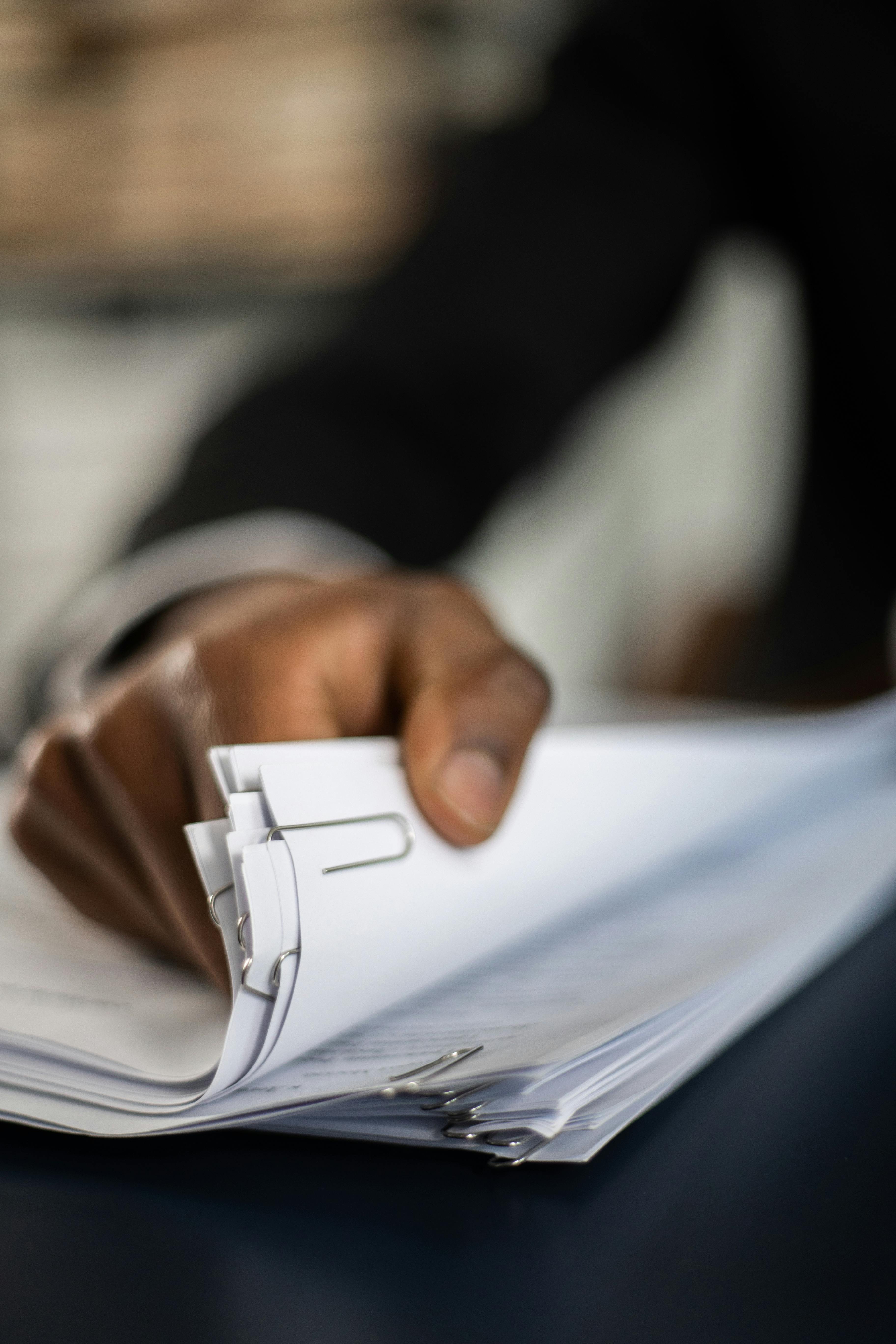 Executive reviewing a one-page project status report in a boardroom setting