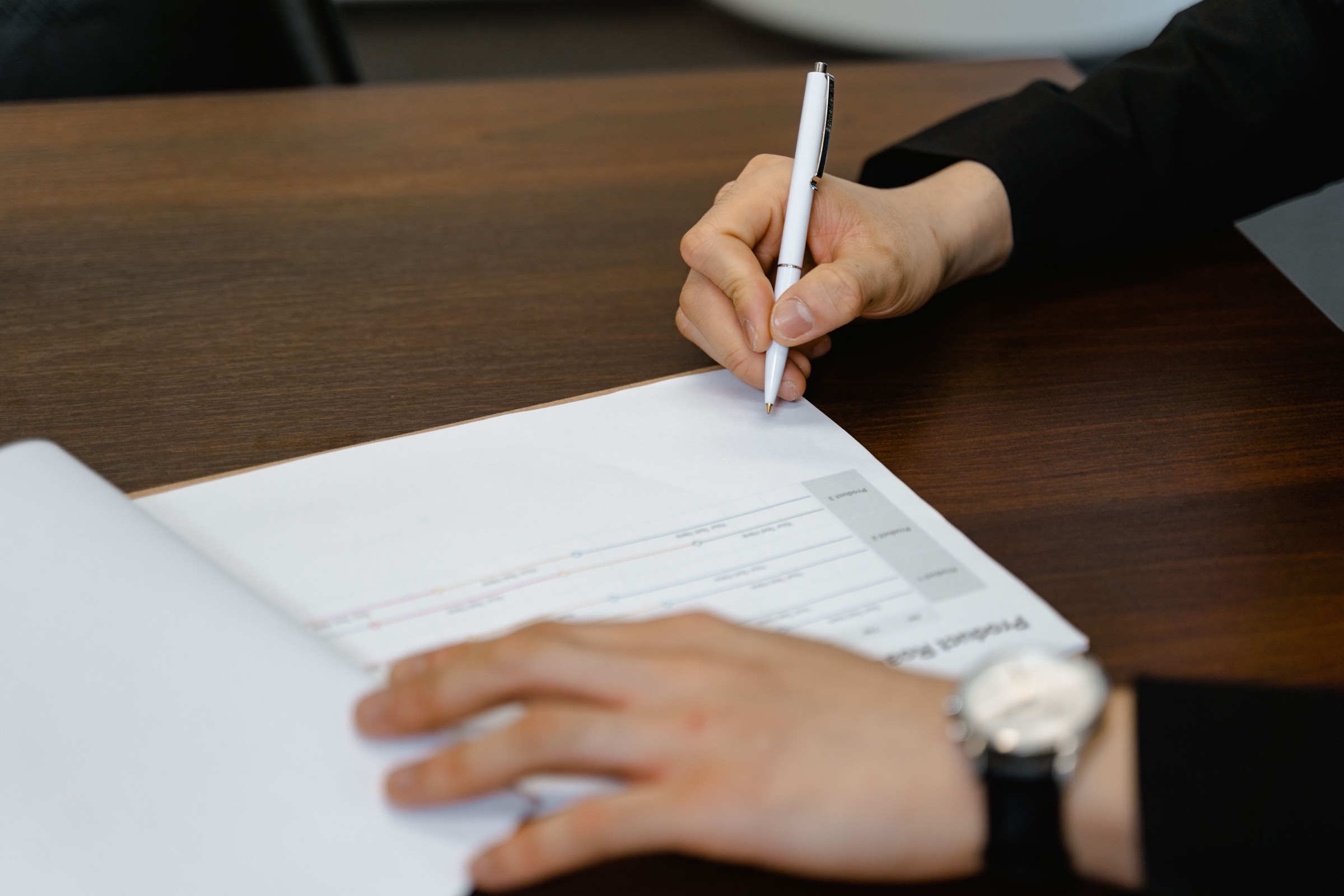 A project charter document on a desk, marking the start of project planning