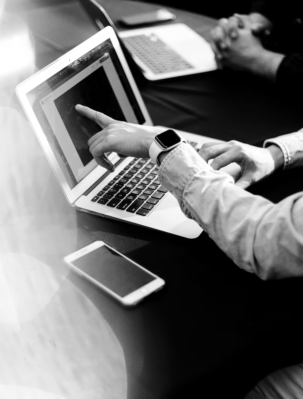 L&D manager and project management leader reviewing training assessment paperwork at a conference table